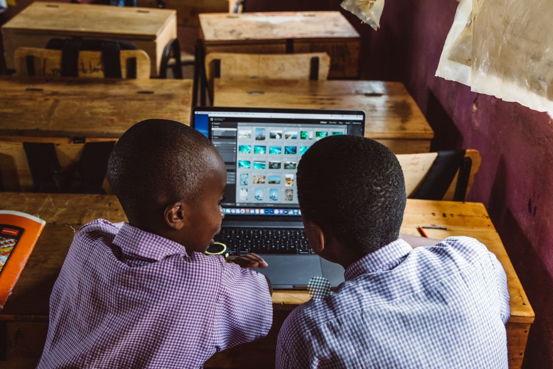 Young African developer or student working on a laptop